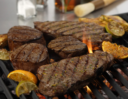 Kansas City Strip Steaks and Filet Mignon on Grill